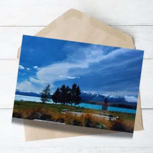 lake tekapo nz view with blue sky and tree around the lake