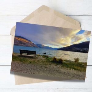 A bench looking toward lake in Queenstown garden a greeting card